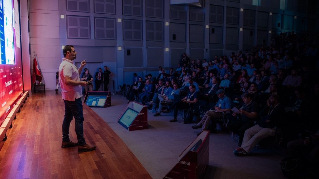 Isidoros Sideridis presenting on a a stage